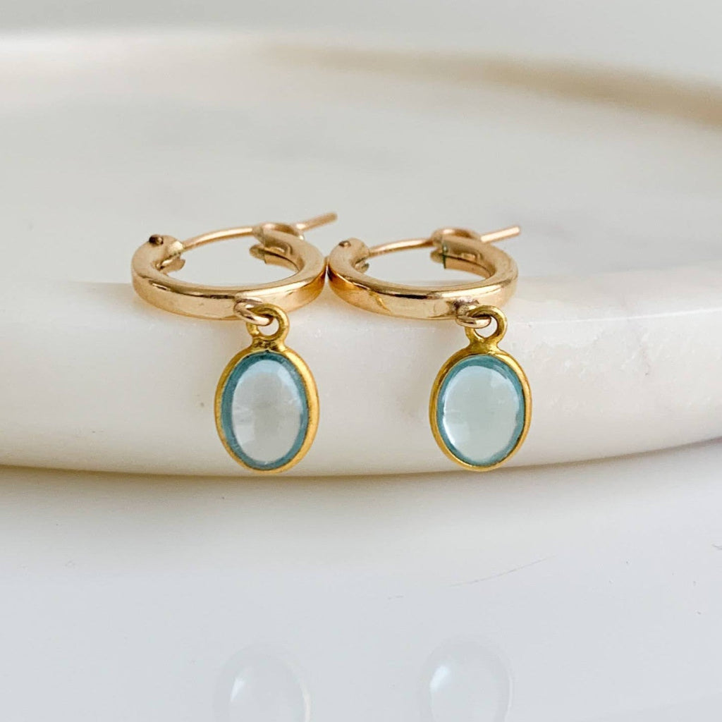 14k gold filled oval bezel sky blue topaz charms shown on gold hoop earrings