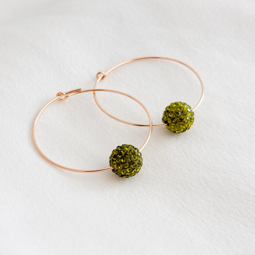 14k gold filled hoop earrings featuring a single olive green crystal ball bead.