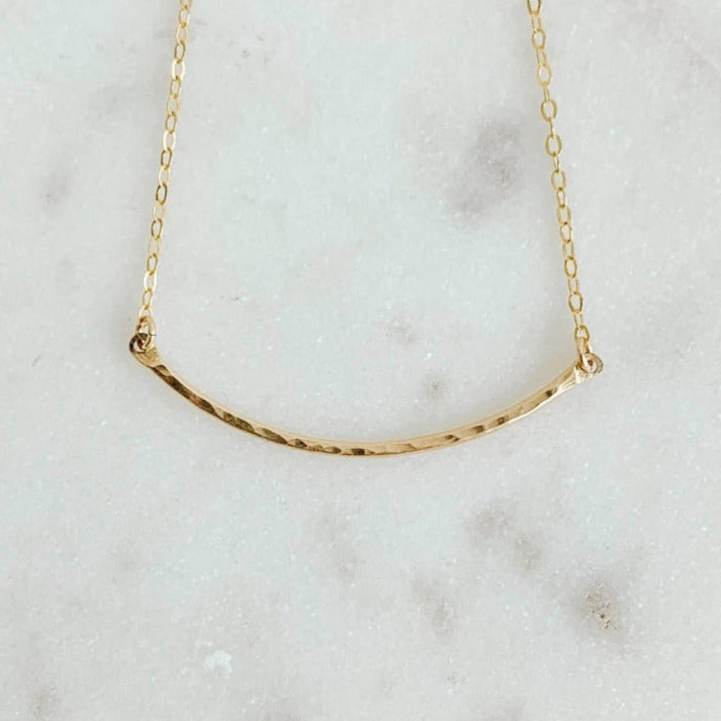 14k gold filled necklace featuring a textured curved pendant set in dainty chain.