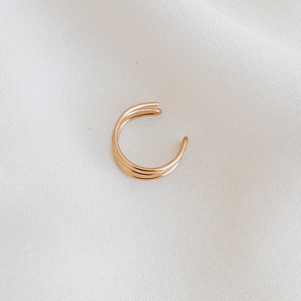 top view of a 14k gold filled triple band wrap ear cuff.