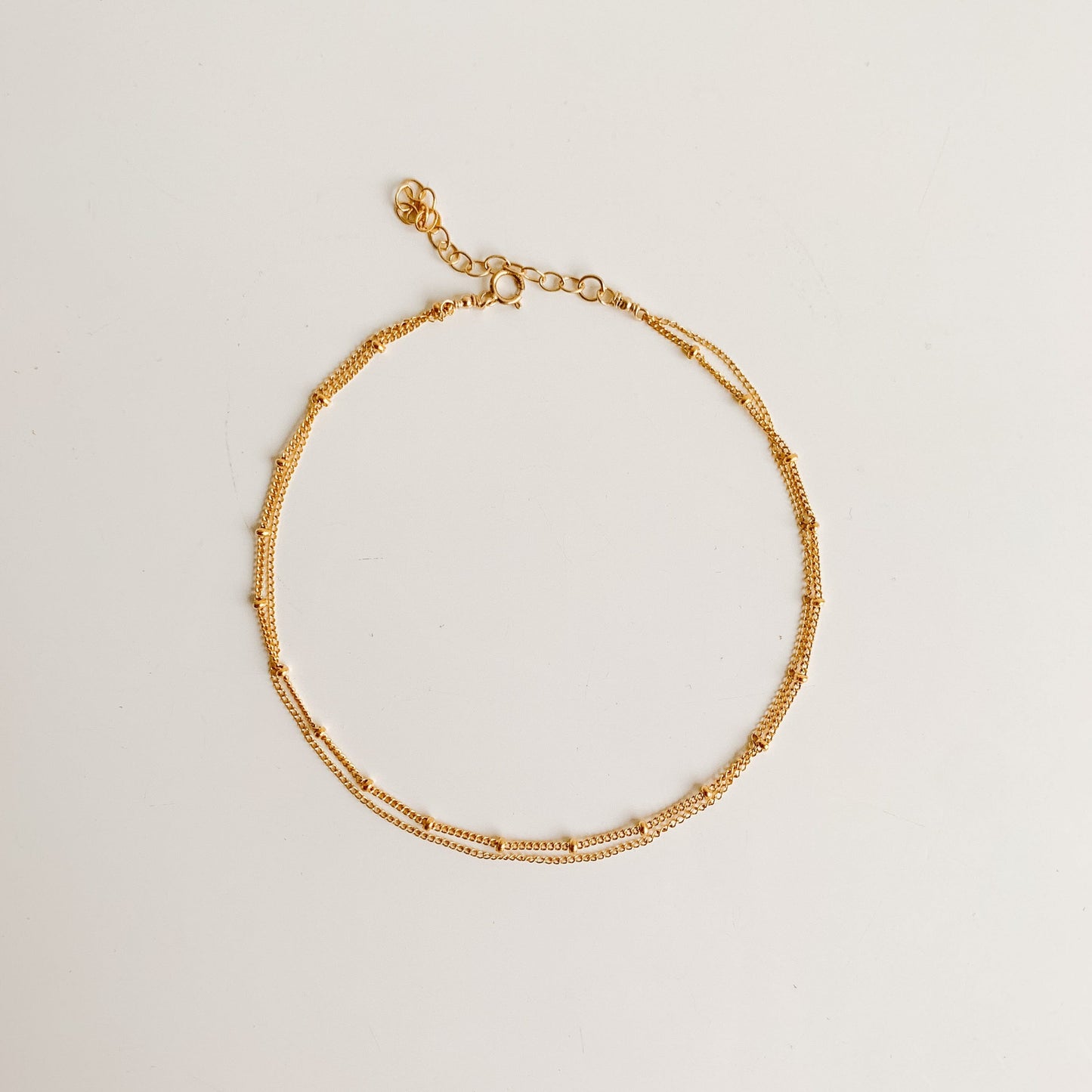 a dainty gold anklet featuring double chain design in 14k yellow gold filled.