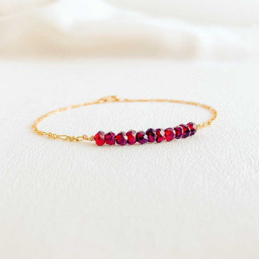 dainty 14k yellow gold filled Figaro chain bracelet with tiny faceted garnet gemstone beads.
