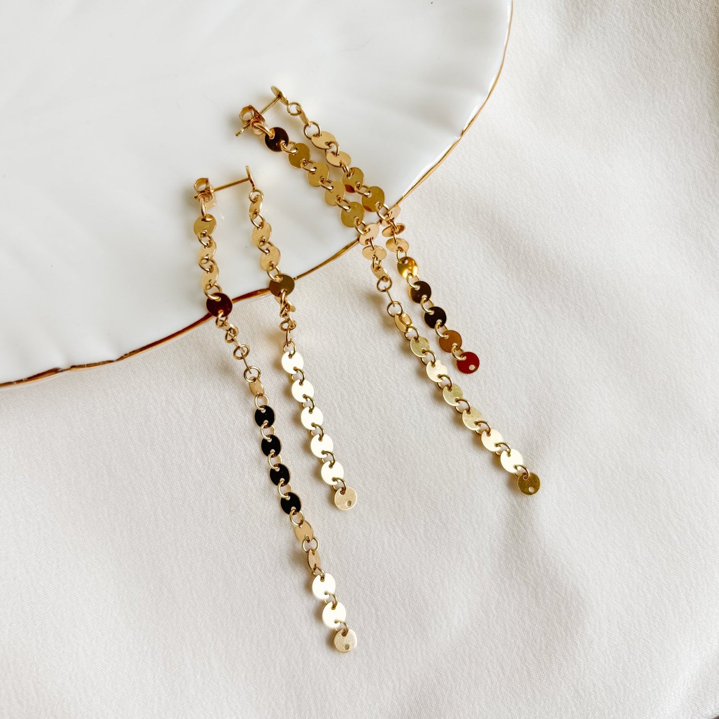 gold disc post earrings in 14K gold filled in front back design. Two lengths of gold disc sequin chain dangle from the post earrings.