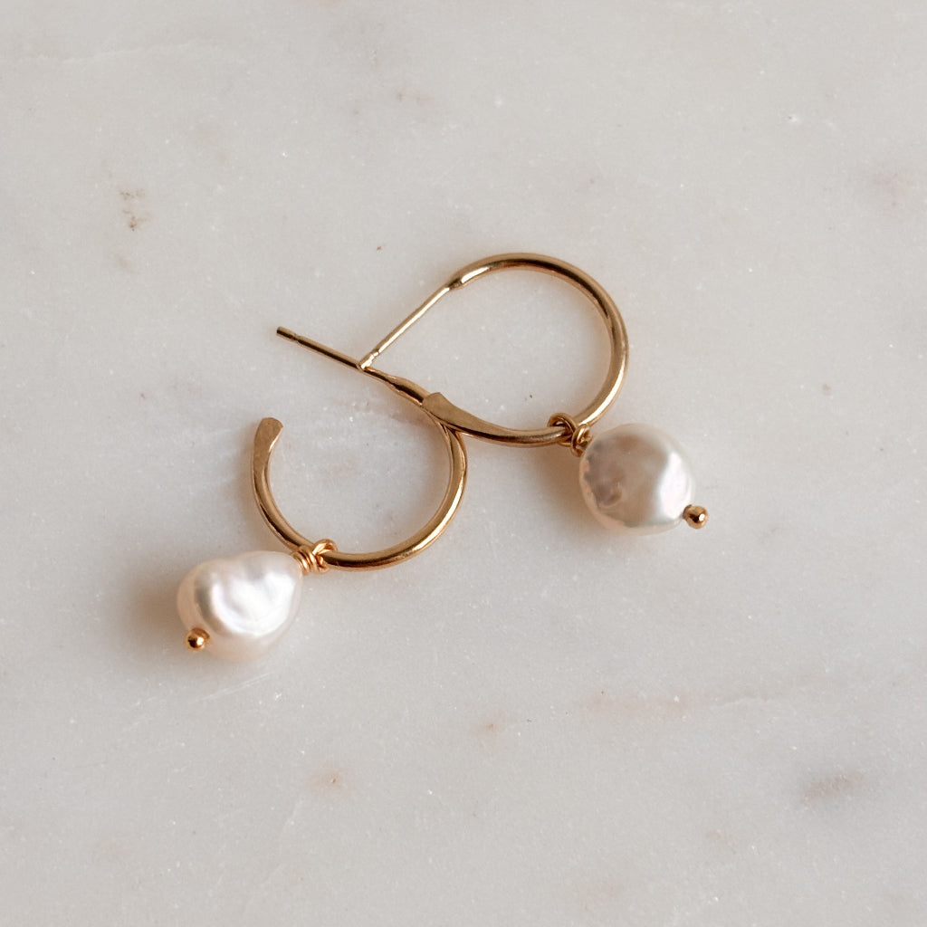 14k gold filled hoop earrings with pearl drops on a light gray background