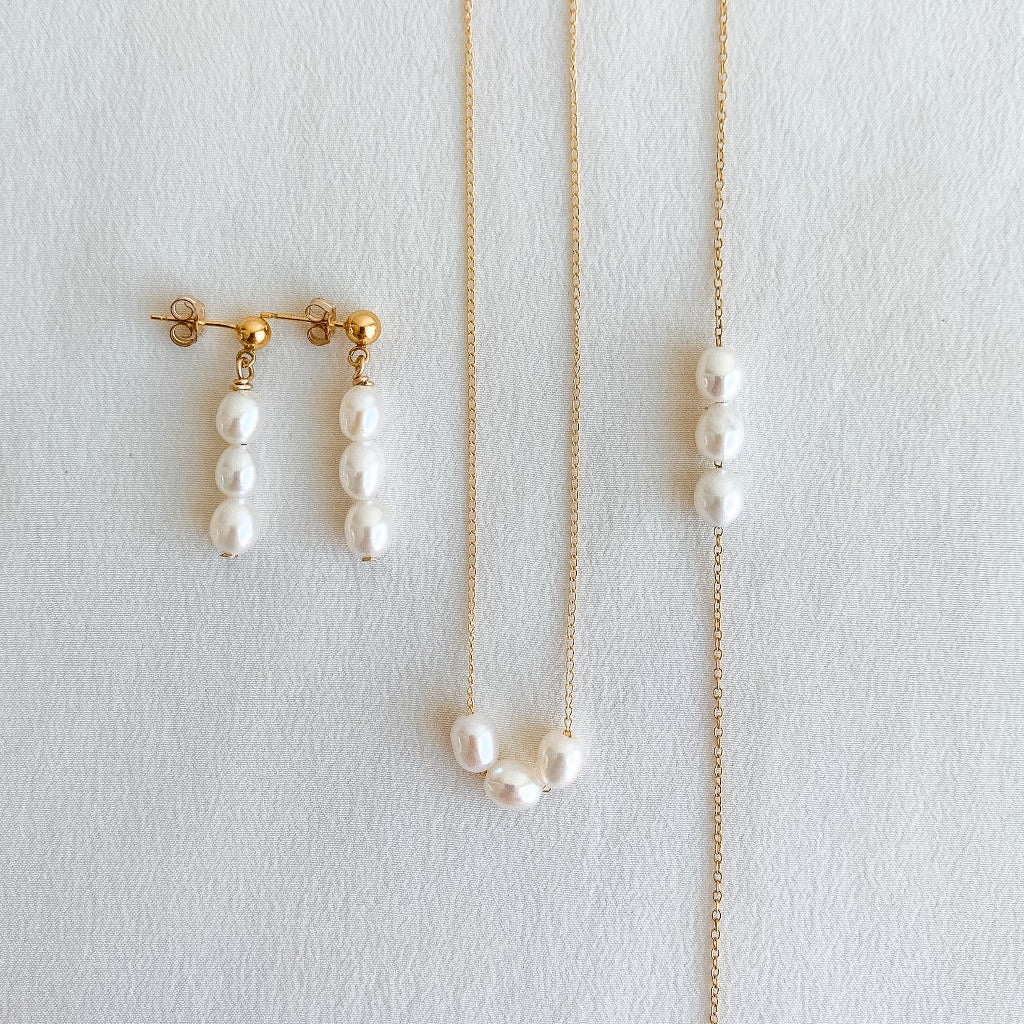 a capsule collection of earrings, bracelet and necklace featuring 3 petite oval pearls.