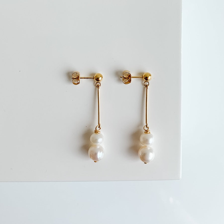pearl drop earrings in 14k gold filled.  The gold ball studs feature gold bars and two pearls that dangle from the end.