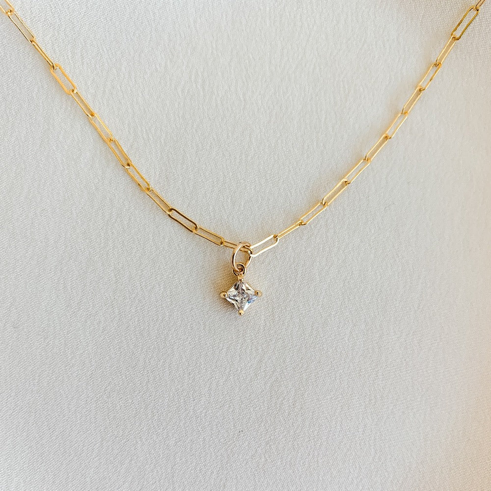 Gold paperclip chain necklace with tiny cubic zirconia pendant.