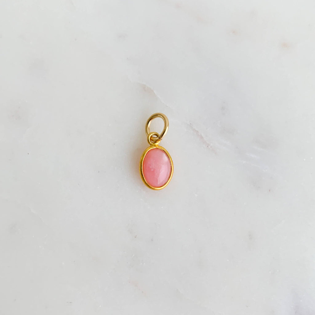 a petite 14k gold filled oval-shaped natural opal pink gemstone charm for hoop earrings or necklaces.
