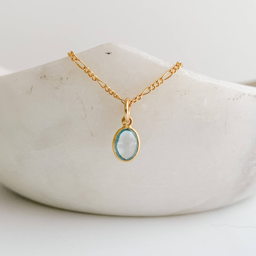 14k gold filled oval bezel sky blue topaz pendant charm on Figaro necklace chain.