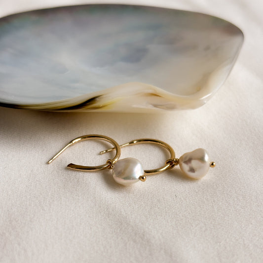 14k Gold filled earrings with baroque keshi pearls on a light background