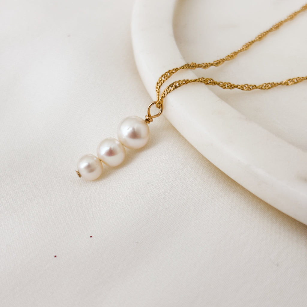 Pearl necklace on a white surface