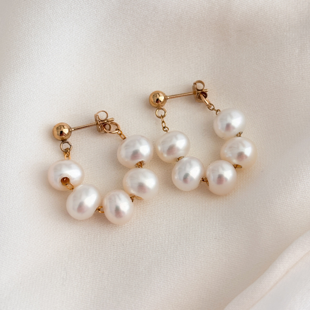 14k gold filled pearl wrap around hoop earrings.  The earrings have gold ball posts and five AAA pearls strung on dainty chain in a front back design that wraps around the lobe to form a hoop.  