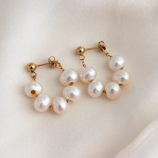 14k gold filled pearl wrap around hoop earrings.  The earrings have gold ball posts and five AAA pearls strung on dainty chain in a front back design that wraps around the lobe to form a hoop.  