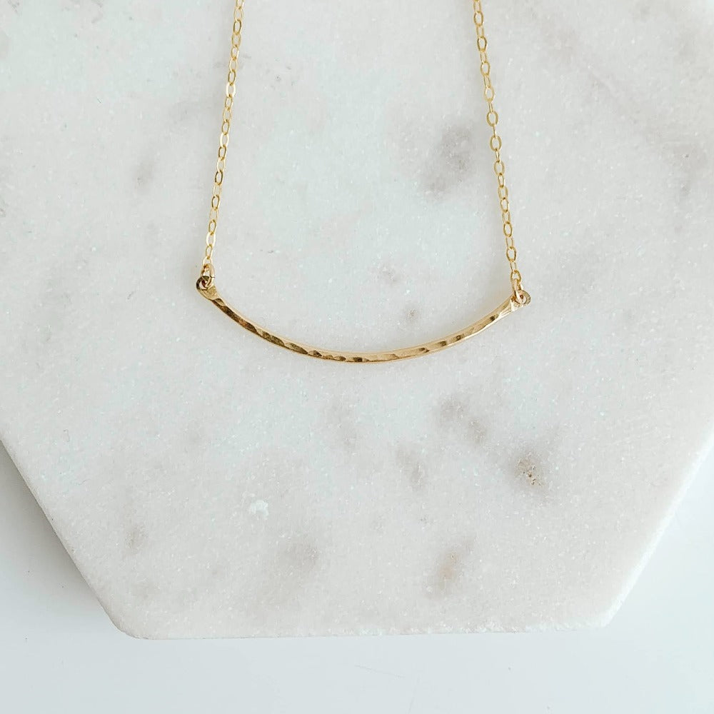 14k gold filled necklace featuring a textured curved pendant set in dainty chain.