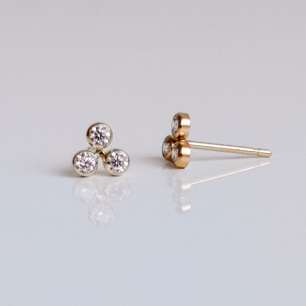 a pair of 14k gold filled triple bezel cz stud earrings.