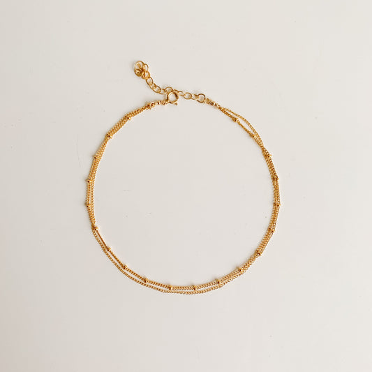 a dainty gold anklet featuring double chain design in 14k yellow gold filled. 
