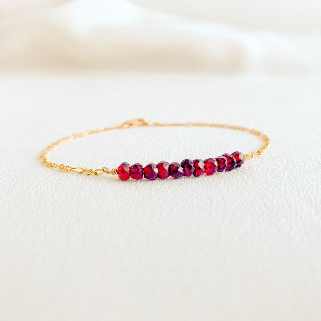 dainty 14k yellow gold filled Figaro chain bracelet with tiny faceted garnet gemstone beads.  