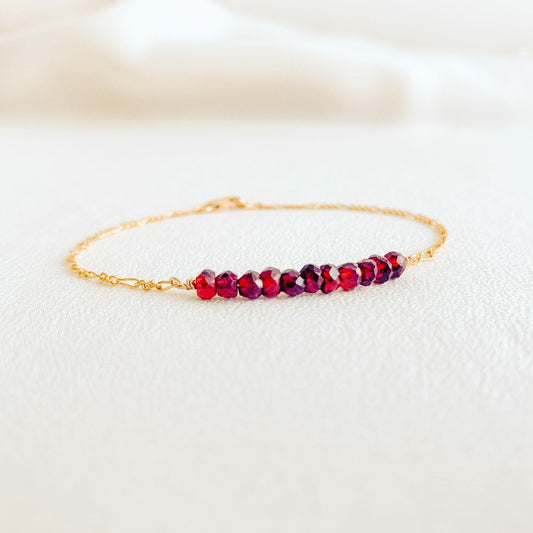 dainty 14k yellow gold filled Figaro chain bracelet with tiny faceted garnet gemstone beads.  