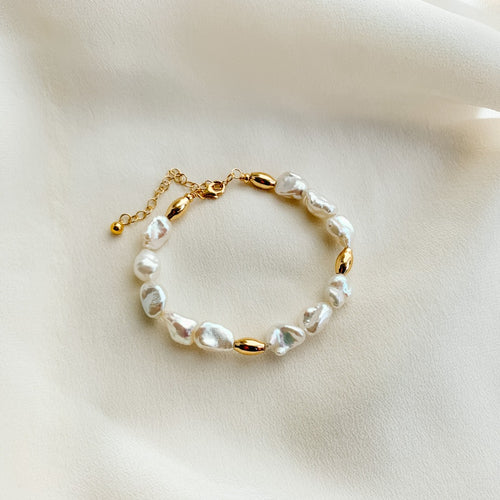 freshwater keshi pearl bracelet by Adorned by Ruth.  Sections of textured pearls are accented with gold oval beads.  14k gold filled. 