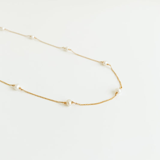 a dainty pearl station necklace in 14k yellow gold filled 