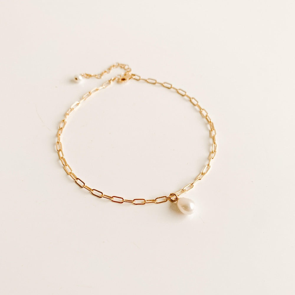 gold chain anklet featuring a single pearl drop.  The chain is elongated rectangle link with a 2" extender and lobster clasp closure ending with a tiny freshwater pearl.  